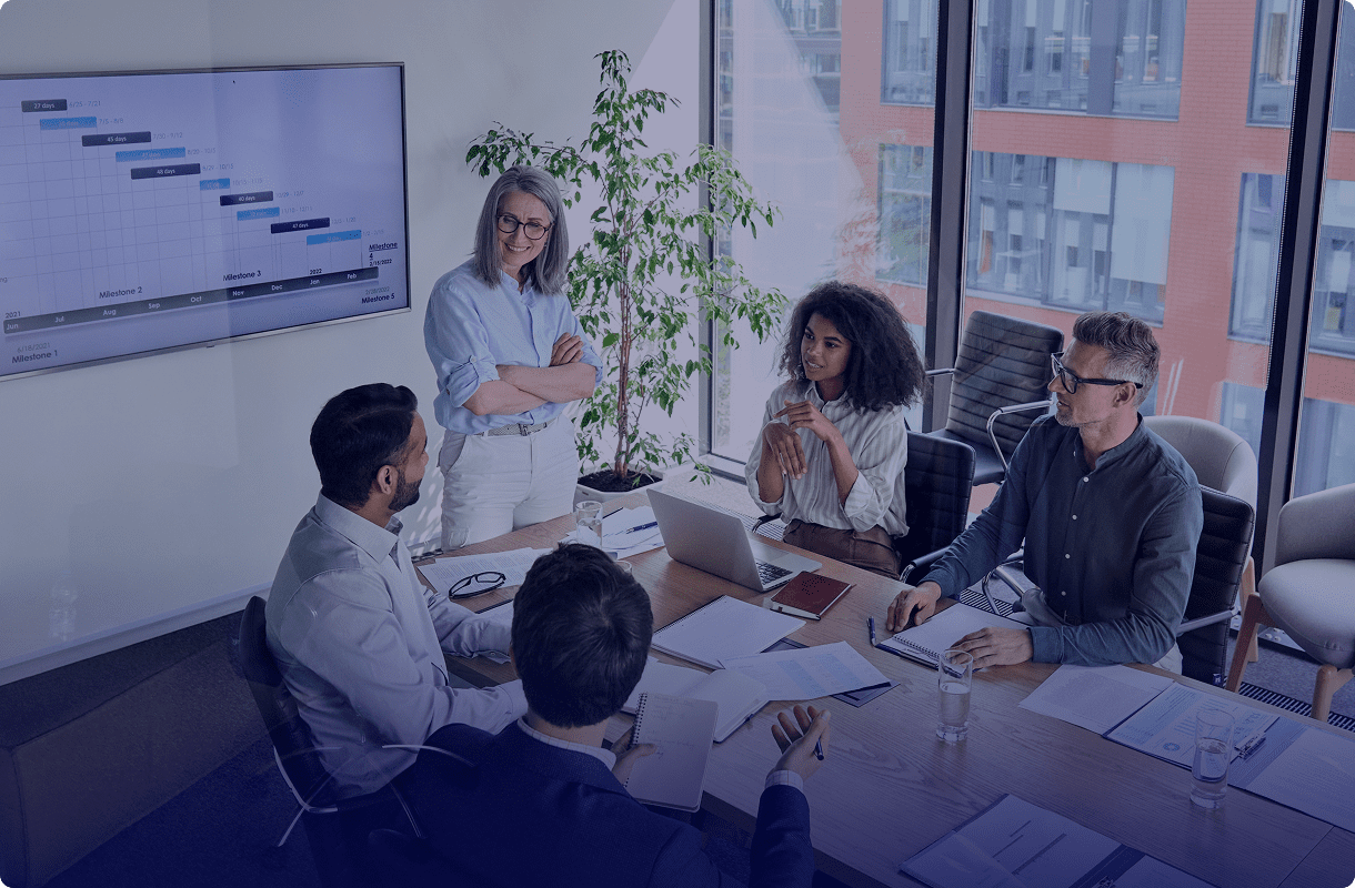 Colleagues discussing project at conference table