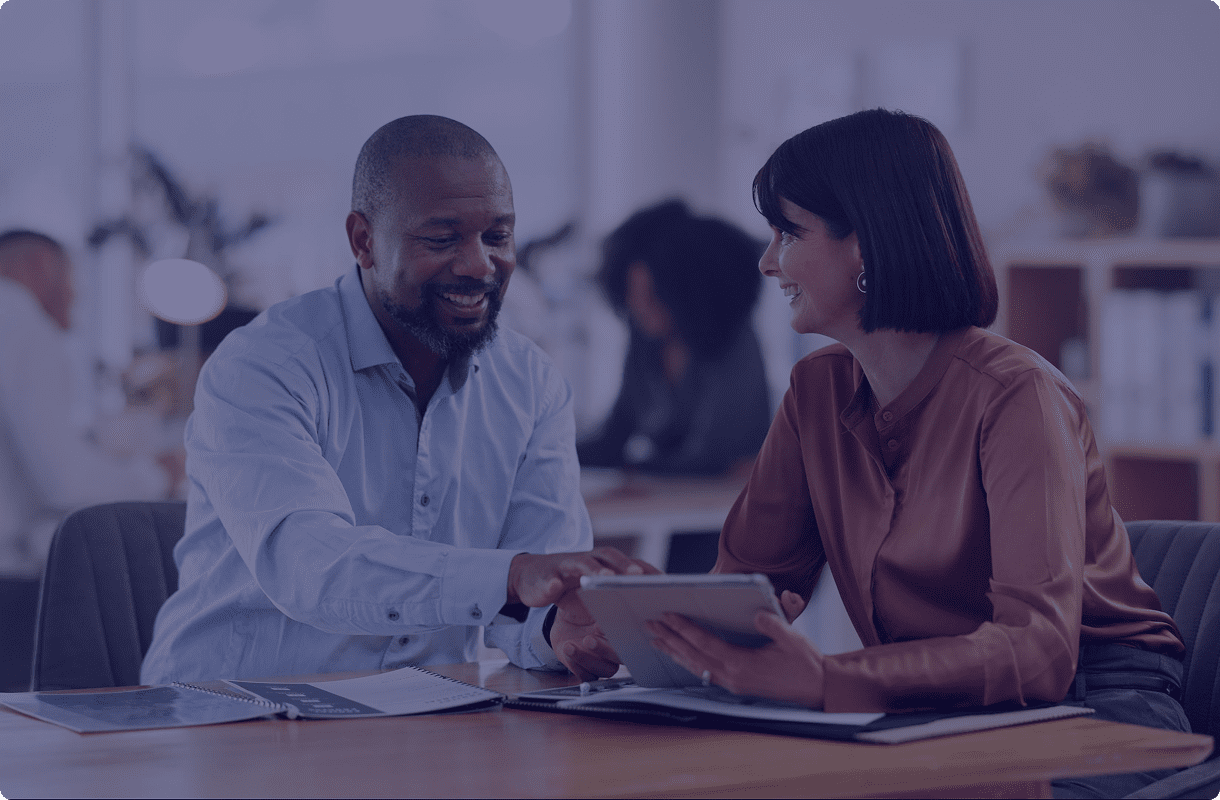 Colleagues discussing work on tablet