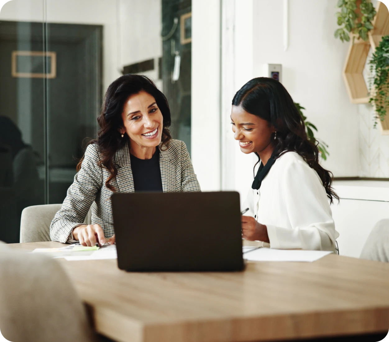 Two women collaborating at a laptop
