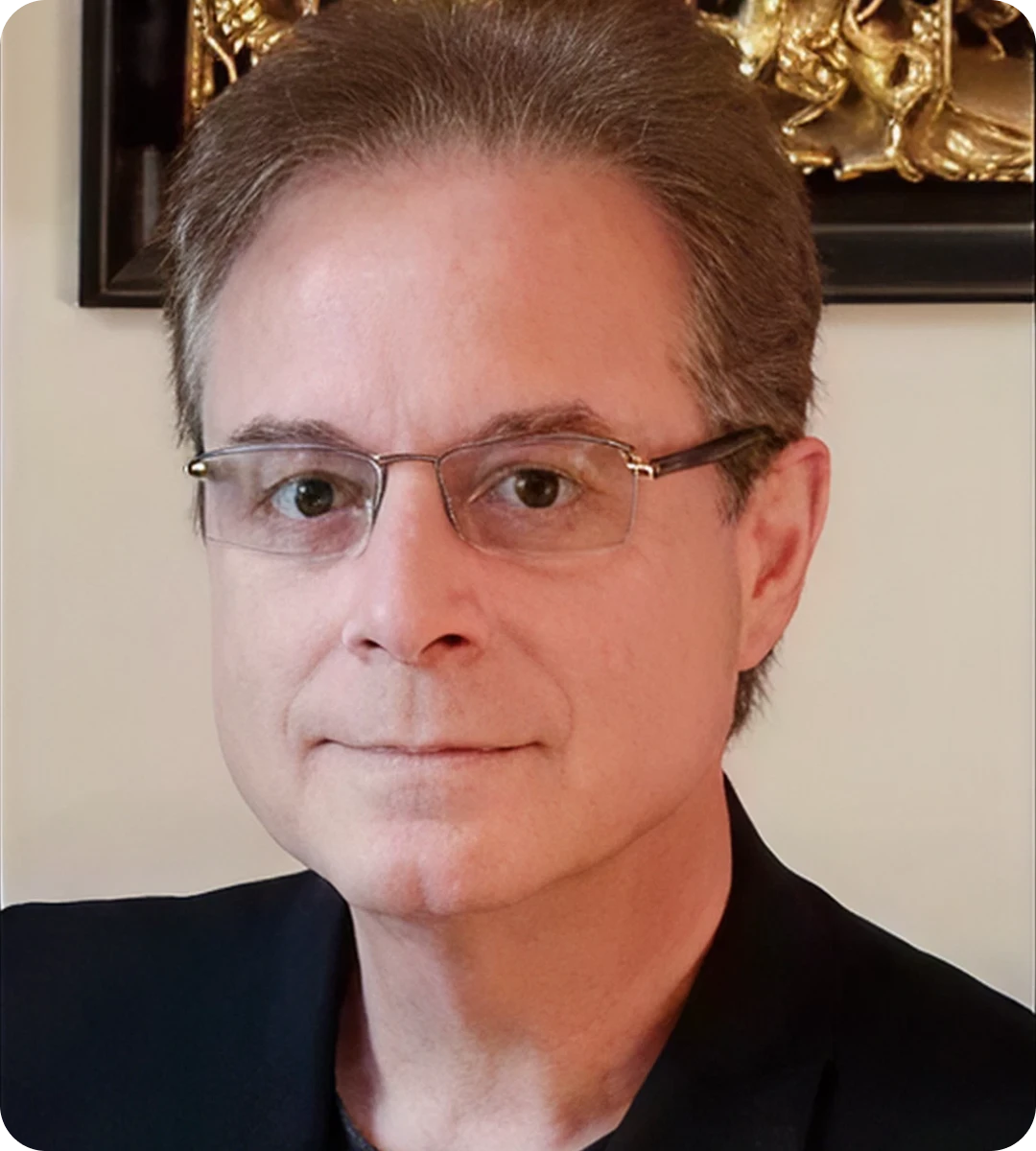 Man wearing glasses and a dark jacket