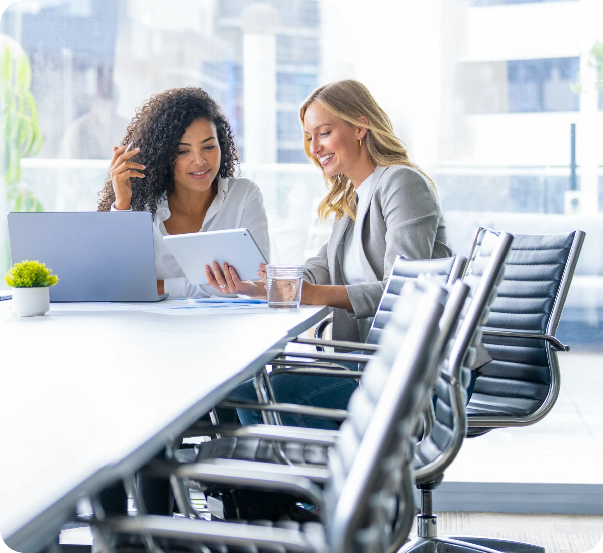 Women collaborating with a tablet in office