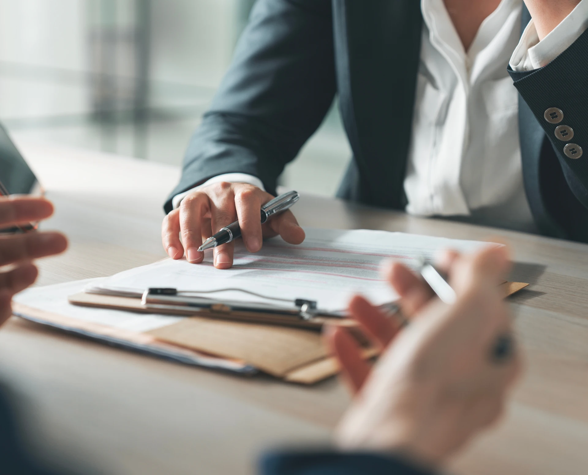 Professionals discussing paperwork at a table